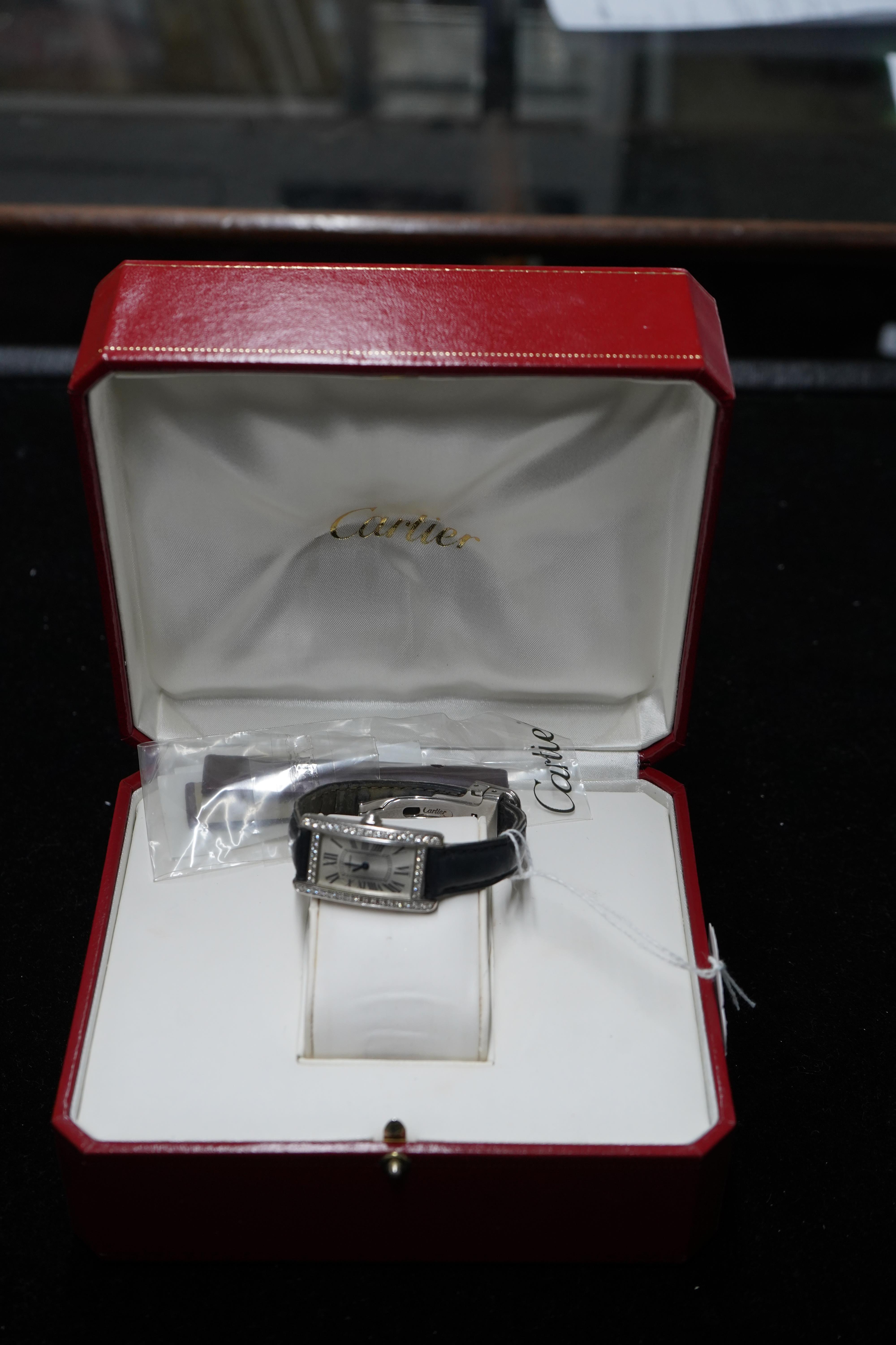 A lady's modern 18ct white gold and diamond set Cartier Tank Americaine quartz wrist watch